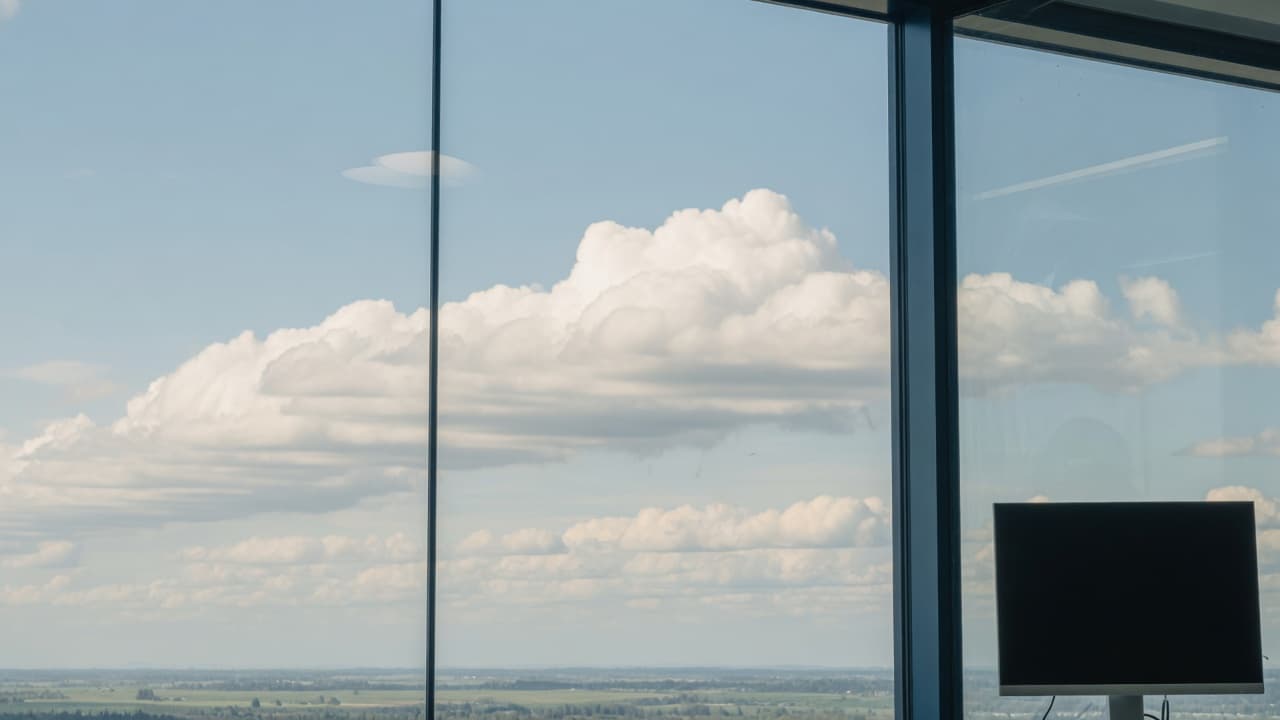 Clouds over the Fraser Valley seen through a modern office window.